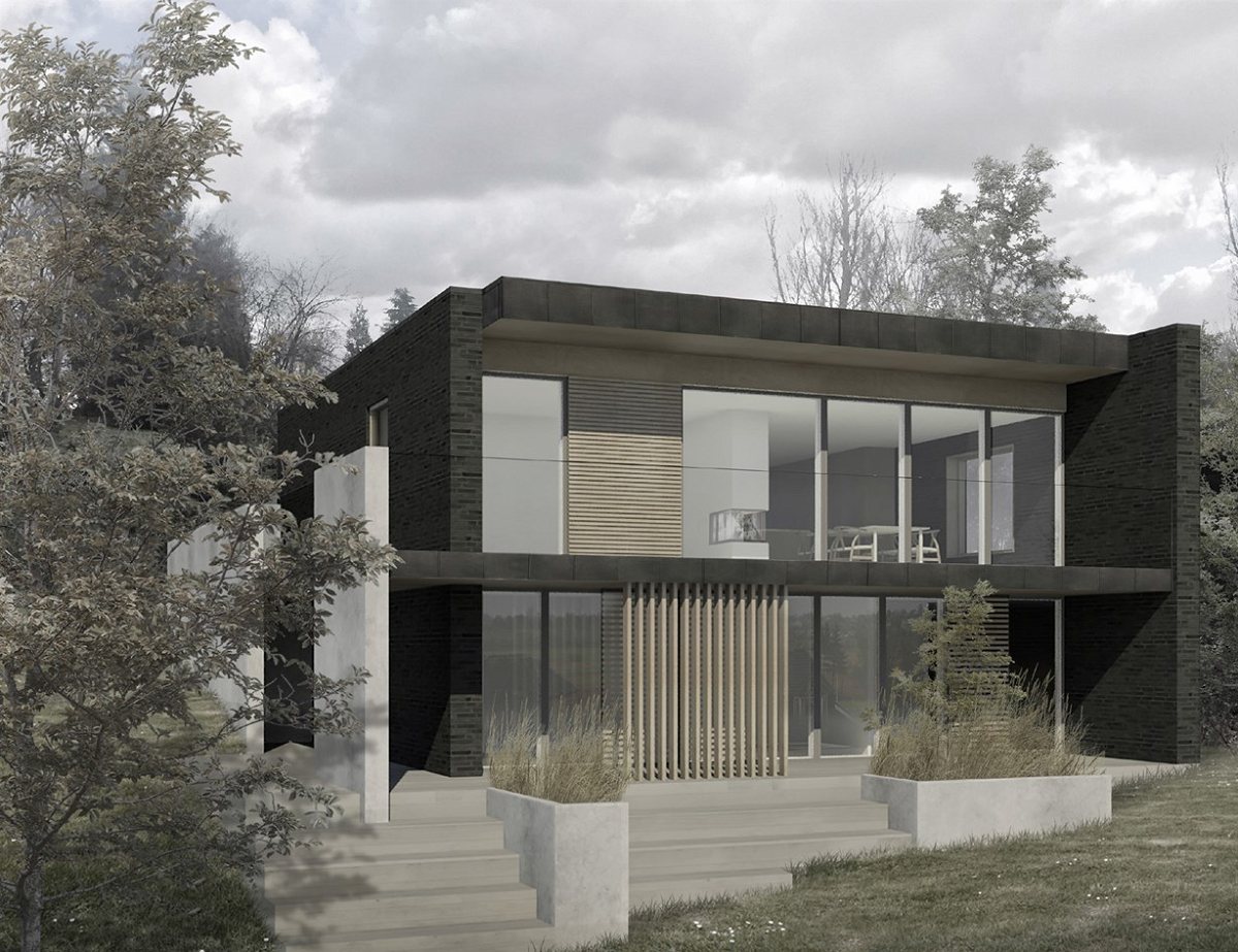 Moderne hus i mørk facade med store glaspartier i naturomgivelser