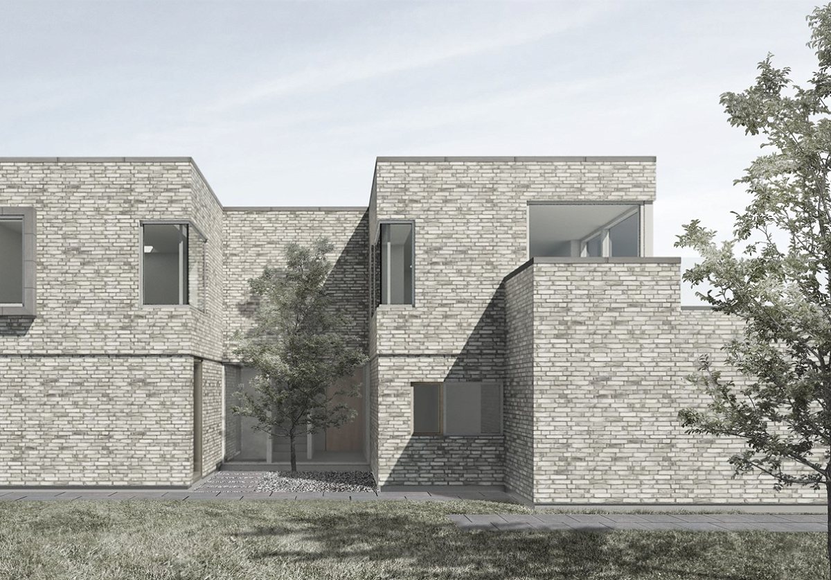 Moderne muret hus i lyse teglsten med atriumgård